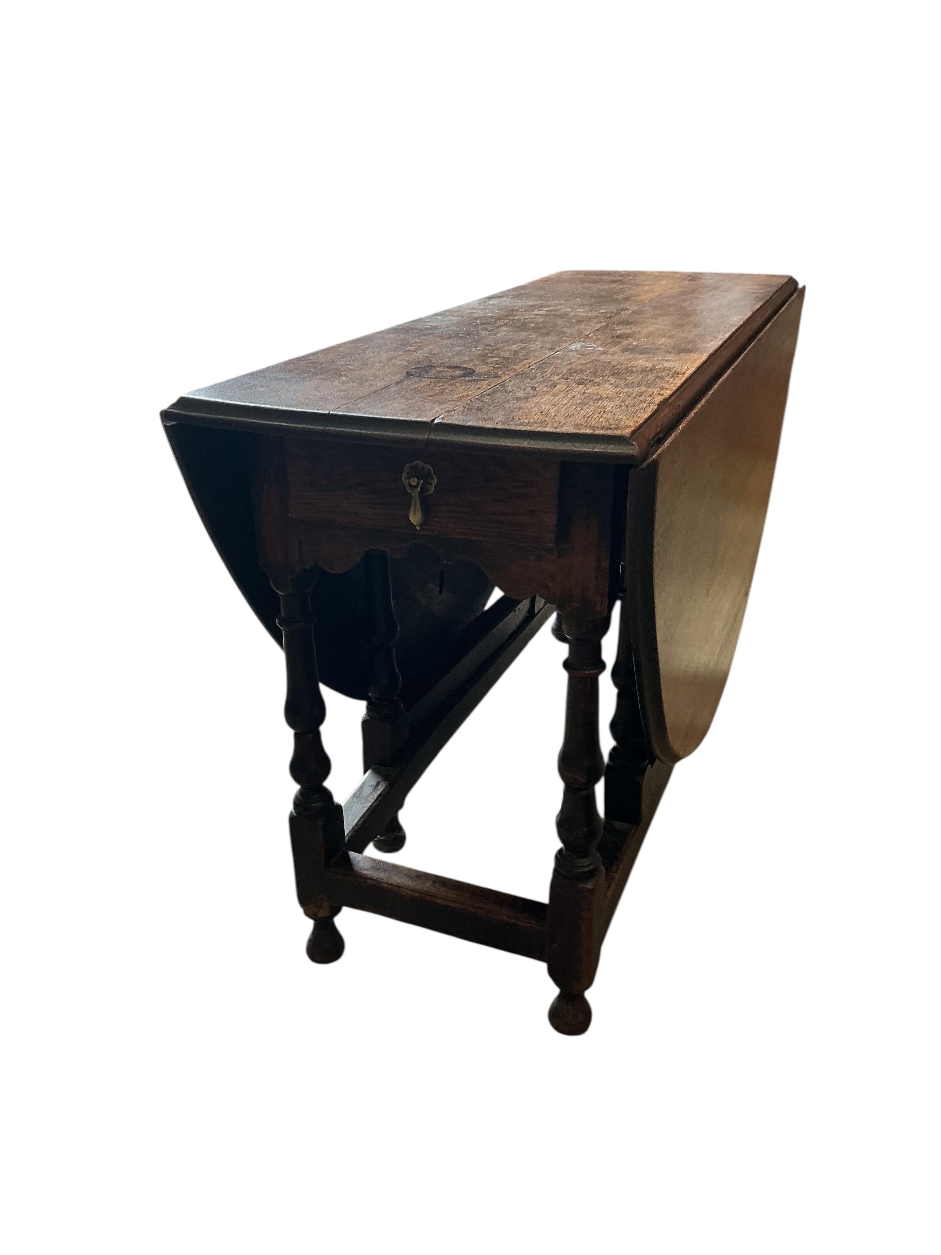An 18th century oak gateleg table, width 130cm, depth 49cm, height 73cm